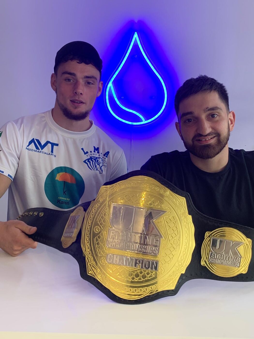 Charlie Lynch-Spence holding a championship belt at Leeds Martial Arts College