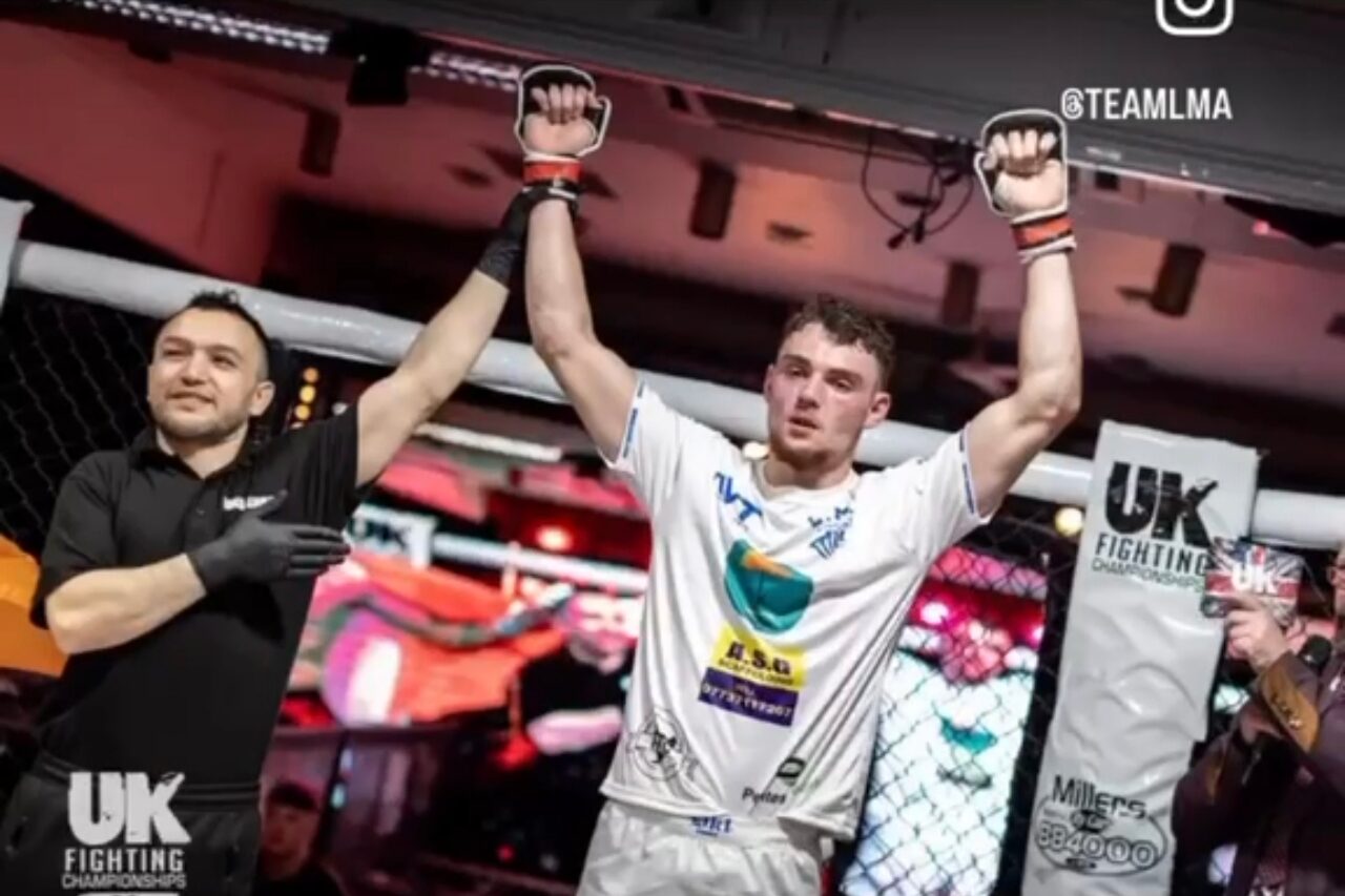 Charlie Lynch-Spence celebrating a win in the cage at a UK Fighting Championship event