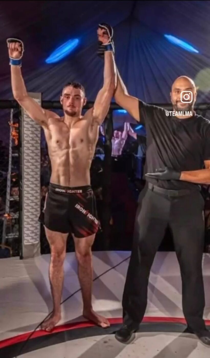 Charlie Lynch-Spence with his hand raised after a fight at a Team LMA event