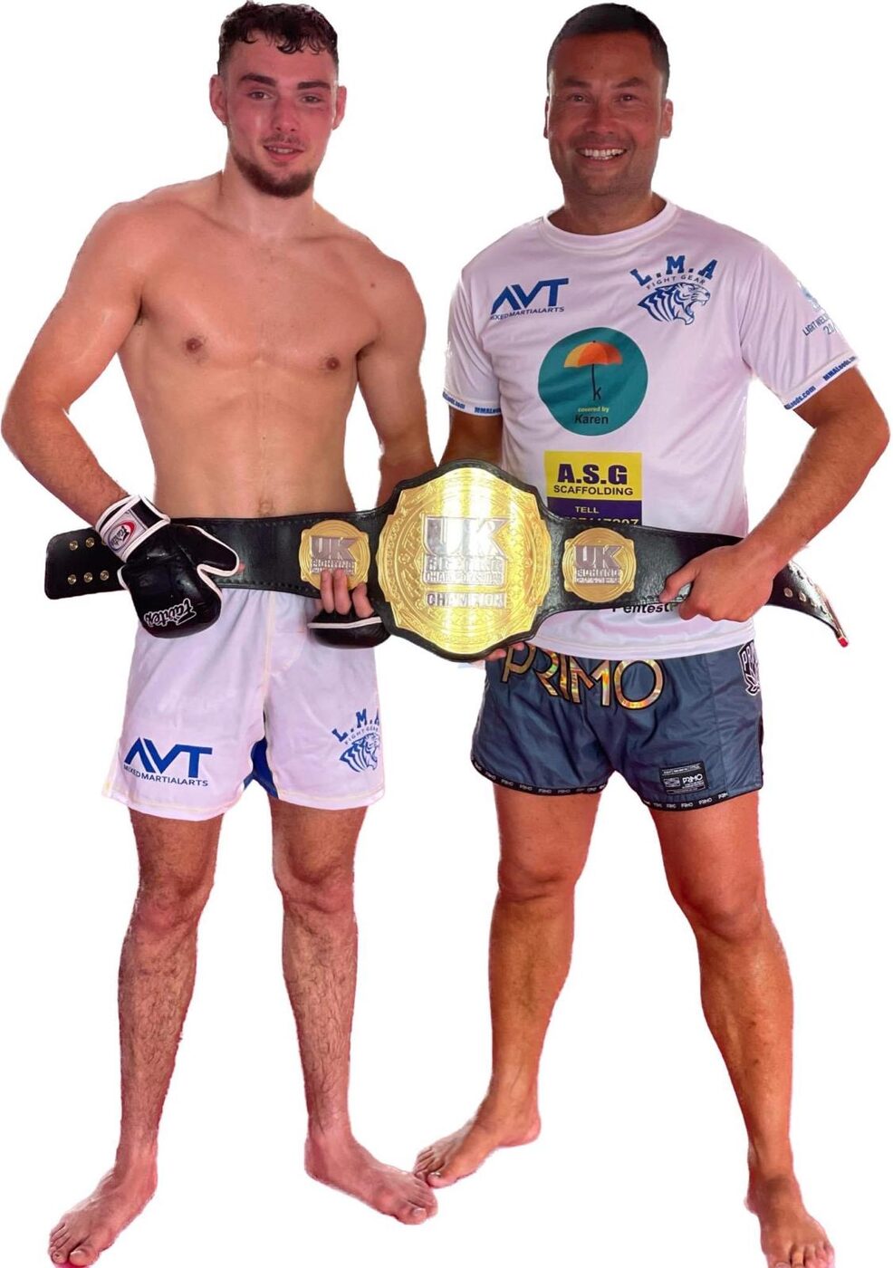 Charlie Lynch-Spence celebrating with a championship belt and coach