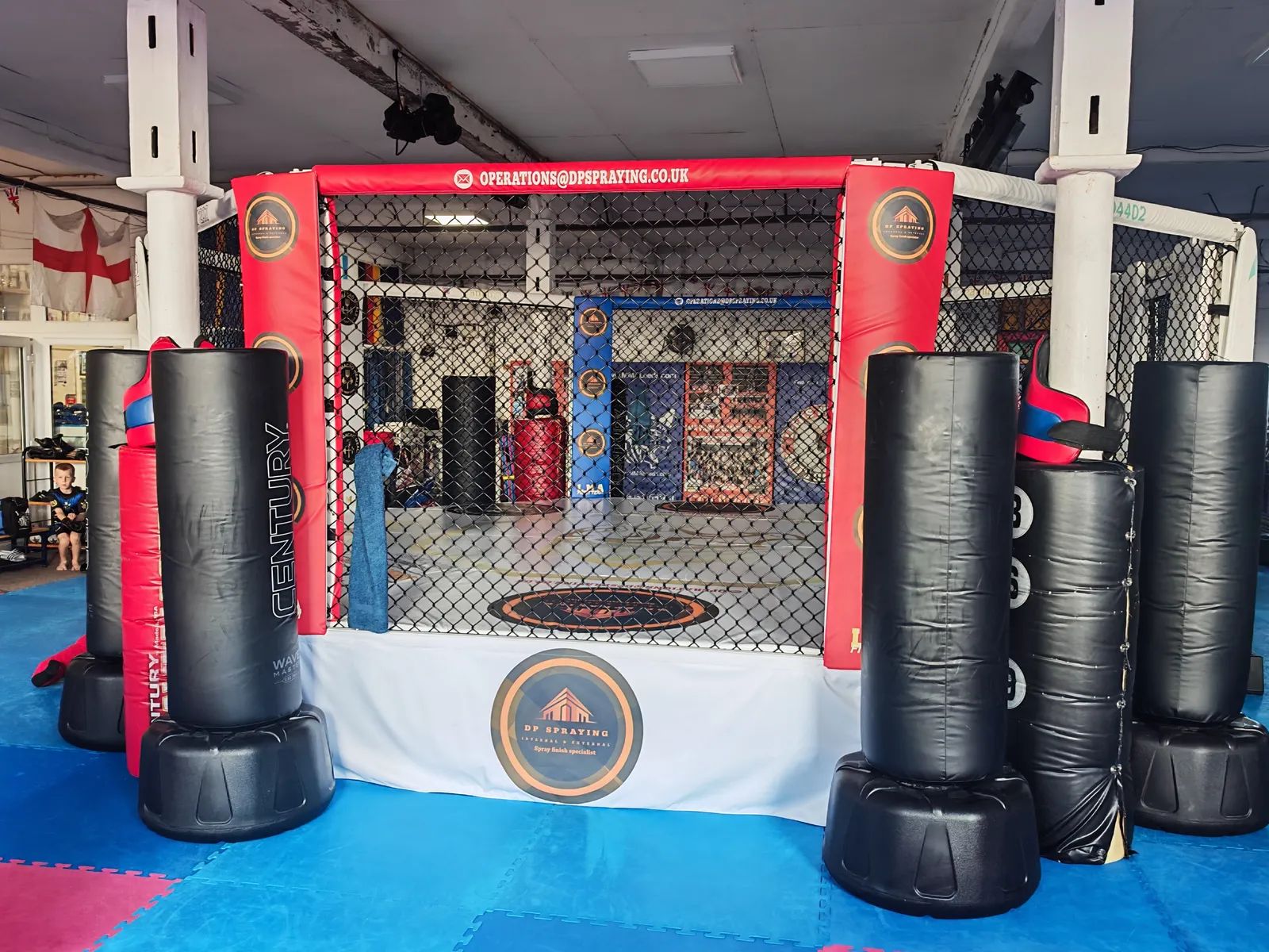 The red and blue MMA cage at Leeds Martial Arts College