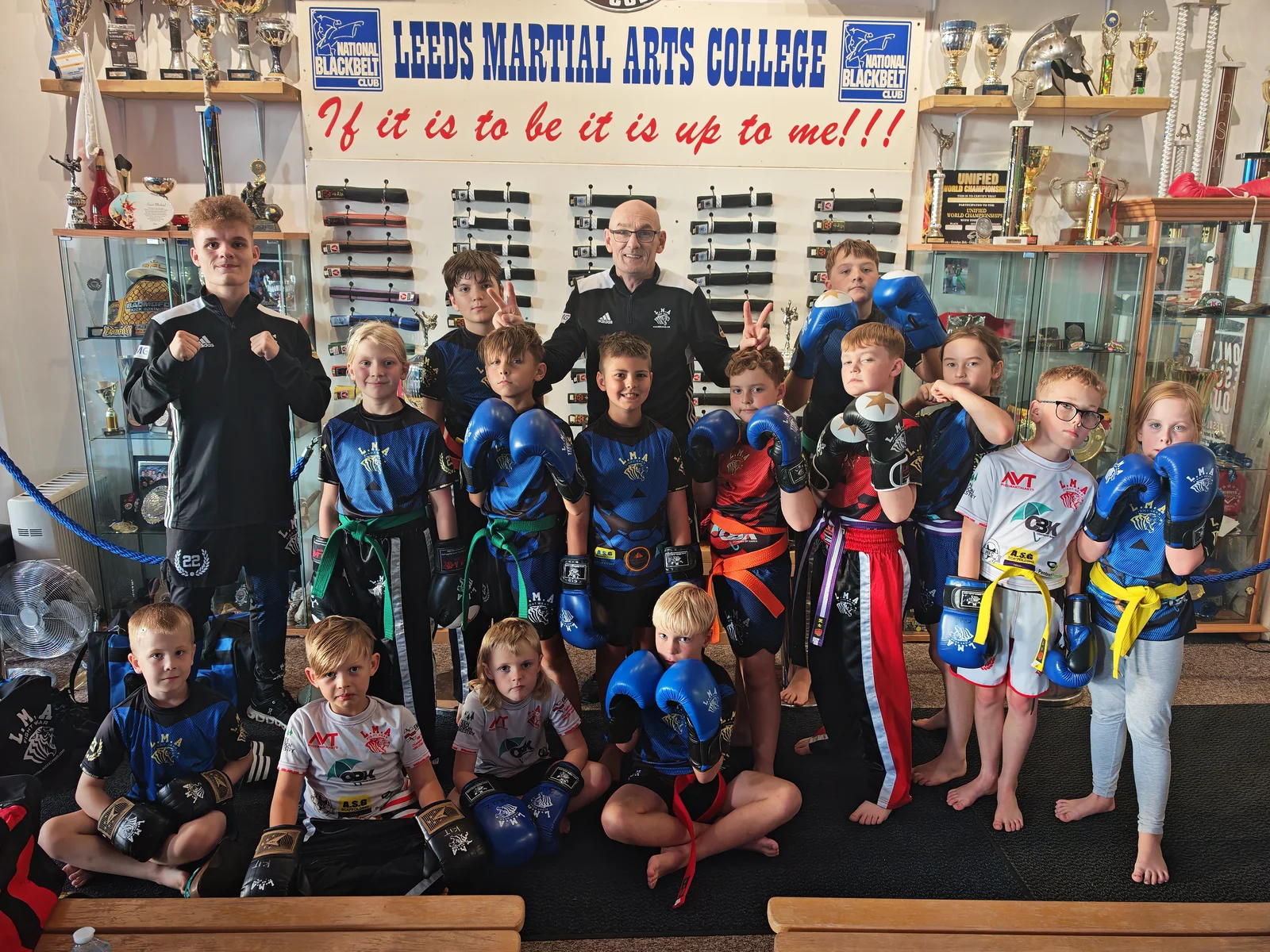 Ninja Kids students with their coach in the LMA trophy room