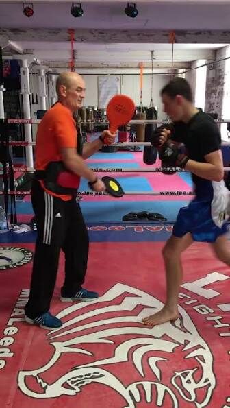 Paul Lynch coaching a fighter on the pads