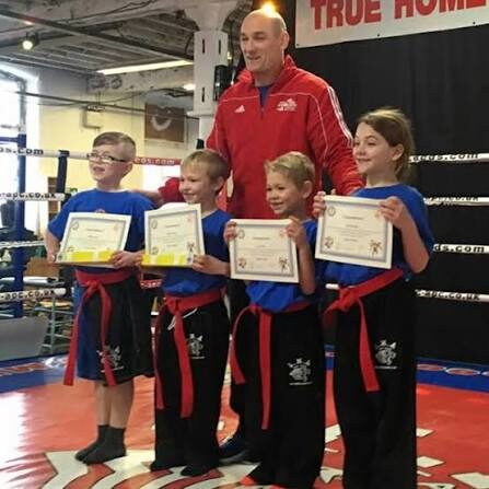 Paul Lynch presenting certificates to junior martial artists