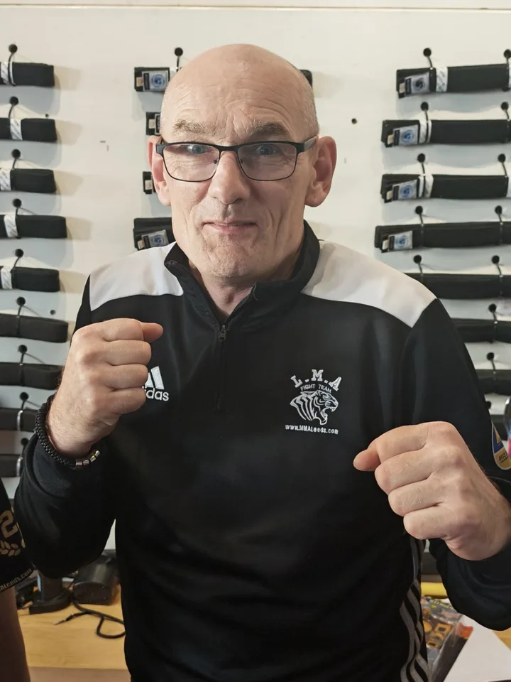 Paul Lynch posing in his LMA coaching kit inside the club
