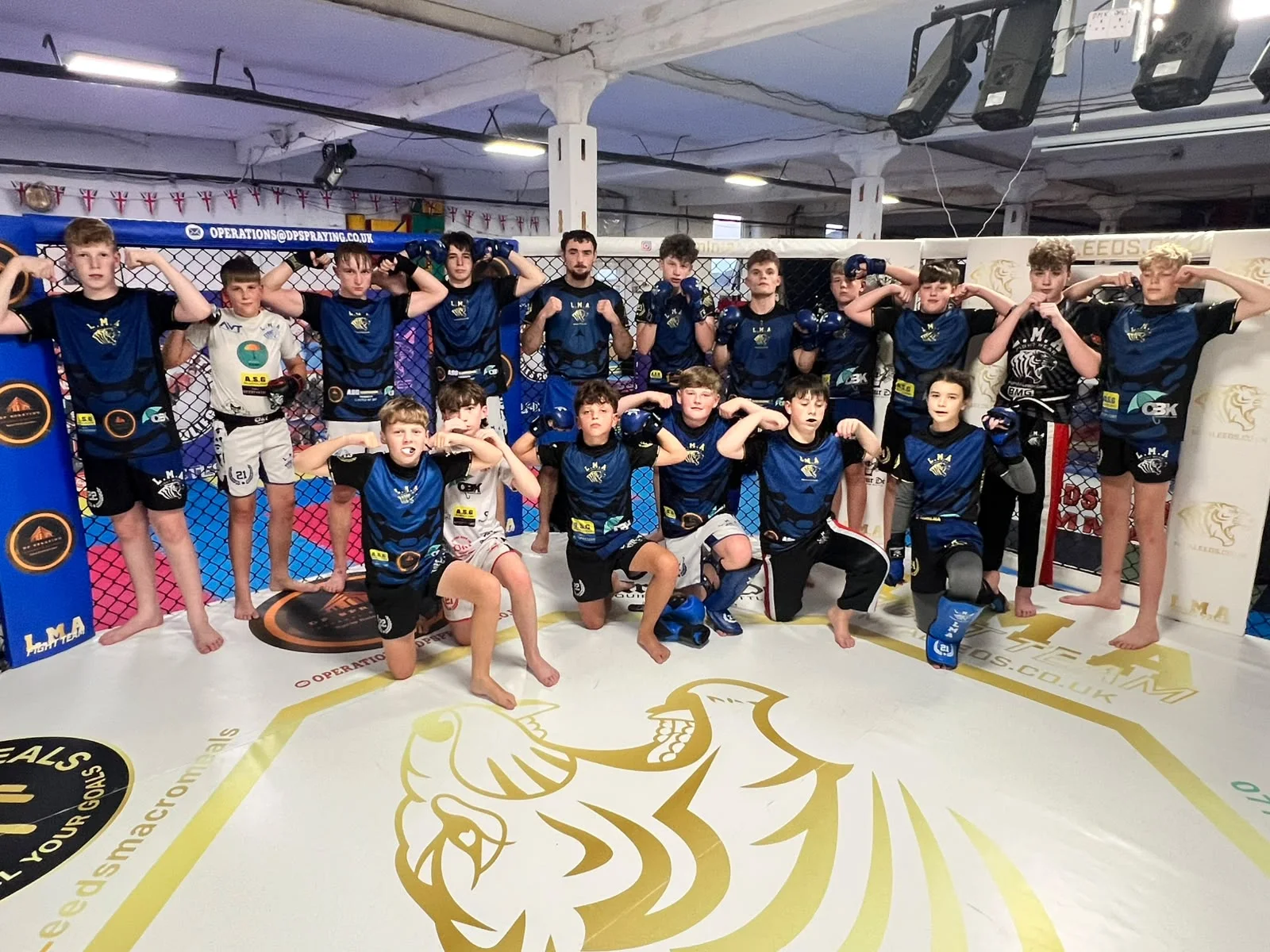 Teens and LMA Fight Team students standing together on the training mat